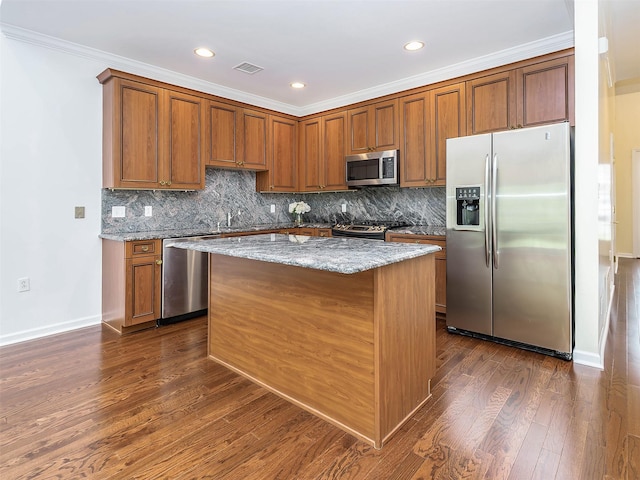 195 Pond View Dr Unit Ca0208, Port Washington, NY 11050 - kitchen with appliances with stainless steel finishes, a center island, light stone counters, backsplash, and recessed lighting