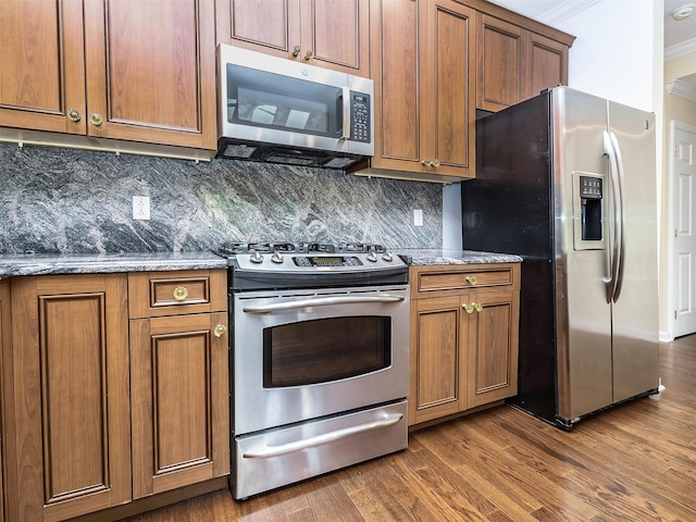 195 Pond View Dr Unit Ca0208, Port Washington, NY 11050 - kitchen with stainless steel appliances, brown cabinets, dark wood finished floors, tasteful backsplash, and crown molding