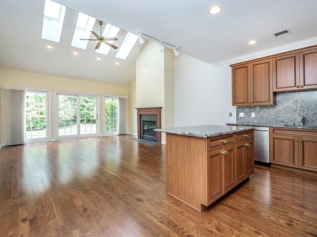 195 Pond View Dr Unit Ca0208, Port Washington, NY 11050 - kitchen featuring dishwasher, open floor plan, stone countertops, dark wood-style flooring, and a center island