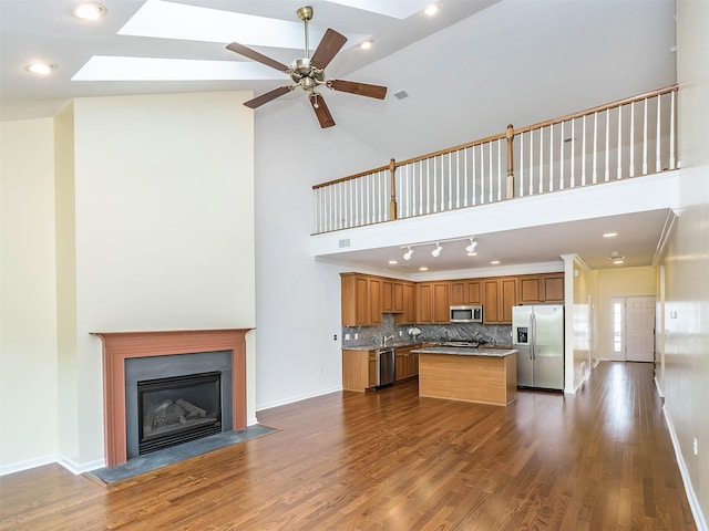 195 Pond View Dr Unit Ca0208, Port Washington, NY 11050 - kitchen featuring stainless steel appliances, a skylight, high vaulted ceiling, ceiling fan, and dark wood-type flooring