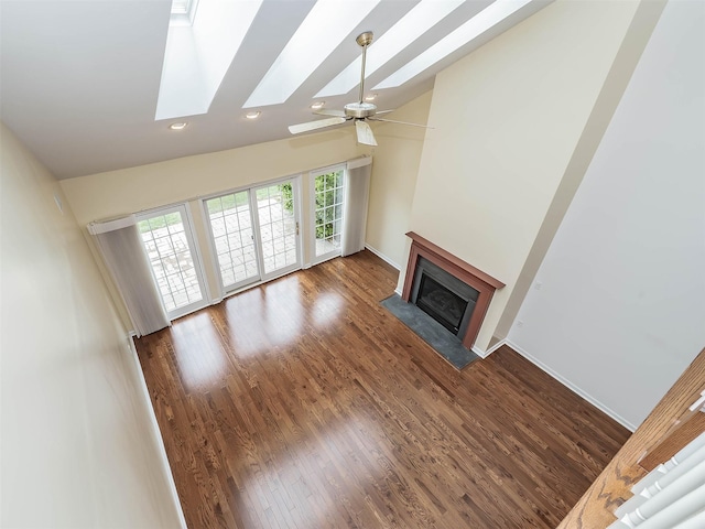 195 Pond View Dr Unit Ca0208, Port Washington, NY 11050 - unfurnished living room featuring a fireplace with flush hearth, recessed lighting, wood finished floors, a skylight, and ceiling fan