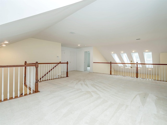 195 Pond View Dr Unit Ca0208, Port Washington, NY 11050 - empty room featuring light carpet, vaulted ceiling, and a skylight