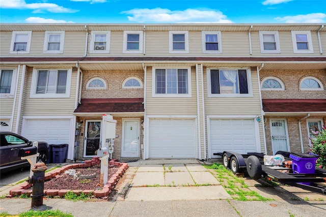 21 Carol Pl, Staten Island, NY 10303 - townhome / multi-family property featuring a garage, driveway, and brick siding