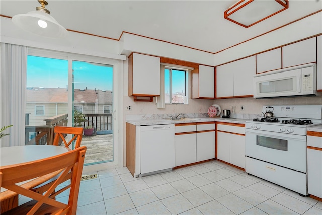21 Carol Pl, Staten Island, NY 10303 - kitchen with white appliances, light countertops, white cabinets, and light tile patterned floors