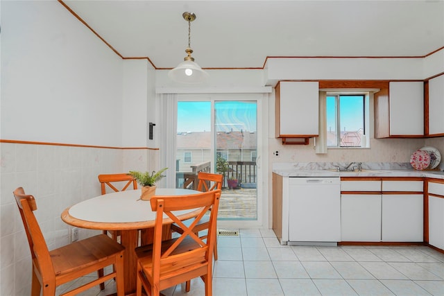 21 Carol Pl, Staten Island, NY 10303 - kitchen featuring white dishwasher, light countertops, white cabinetry, hanging light fixtures, and ornamental molding