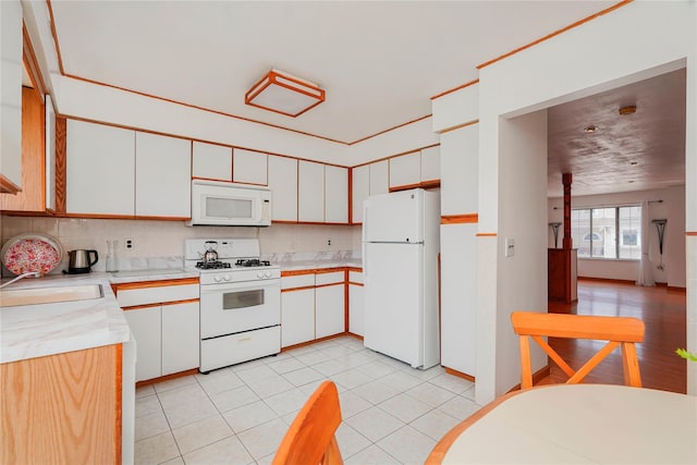 21 Carol Pl, Staten Island, NY 10303 - kitchen featuring white appliances, light countertops, white cabinets, tasteful backsplash, and light tile patterned floors