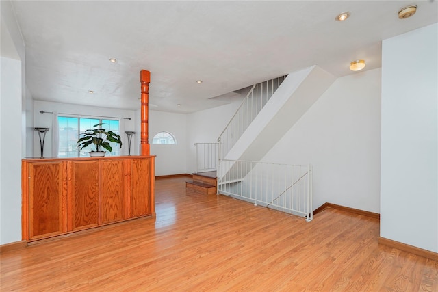 21 Carol Pl, Staten Island, NY 10303 - unfurnished living room with light wood-style floors, stairway, and recessed lighting