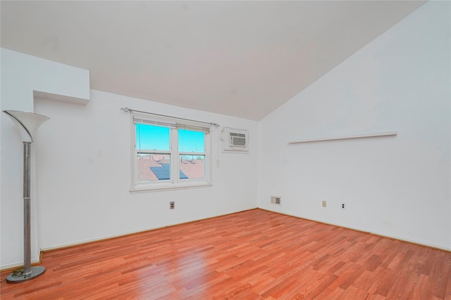 21 Carol Pl, Staten Island, NY 10303 - unfurnished room featuring light wood finished floors, lofted ceiling, and a wall unit AC
