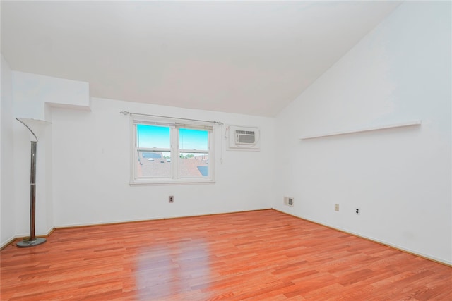 21 Carol Pl, Staten Island, NY 10303 - spare room featuring a wall mounted air conditioner, light wood finished floors, and lofted ceiling
