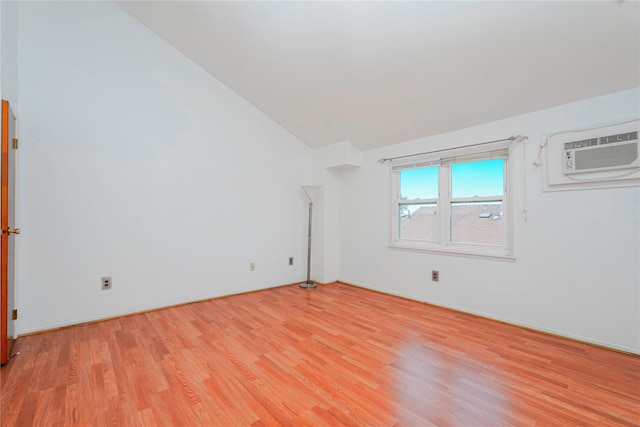 21 Carol Pl, Staten Island, NY 10303 - spare room featuring vaulted ceiling, light wood-type flooring, and a wall mounted air conditioner