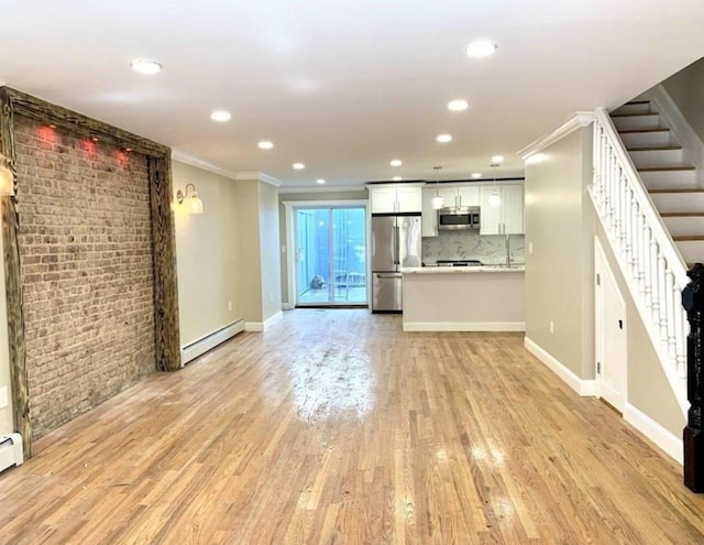 2301 Bathgate Ave, Bronx, NY 10458 - unfurnished living room with baseboard heating, crown molding, stairs, light wood finished floors, and recessed lighting
