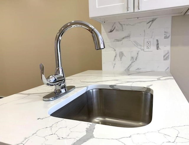 2301 Bathgate Ave, Bronx, NY 10458 - kitchen view of light stone counters, tasteful backsplash, and white cabinets