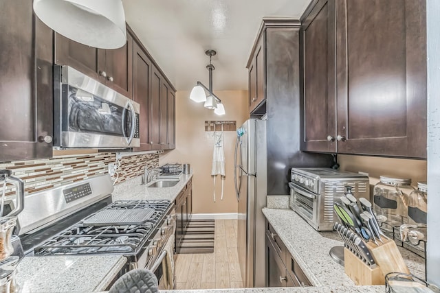 101 Highland Ave Unit 6R, Yonkers, NY 10705 - kitchen with appliances with stainless steel finishes, dark brown cabinets, light wood-style flooring, and tasteful backsplash