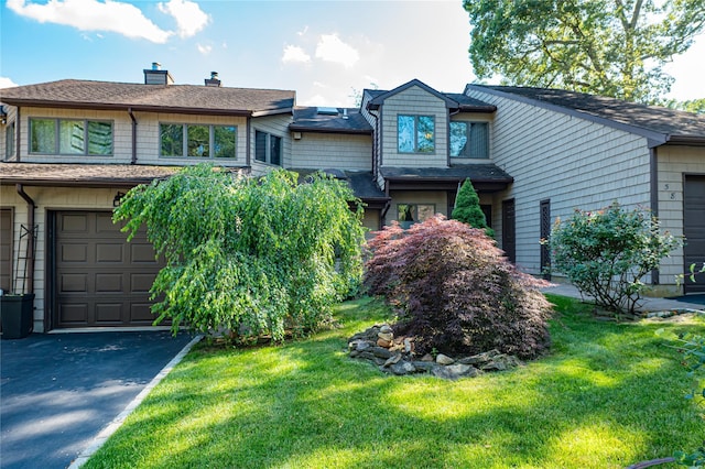 60 Jeremy Cir, Nesconset, NY 11767 - view of front of house with a front lawn, asphalt driveway, a chimney, and roof with shingles
