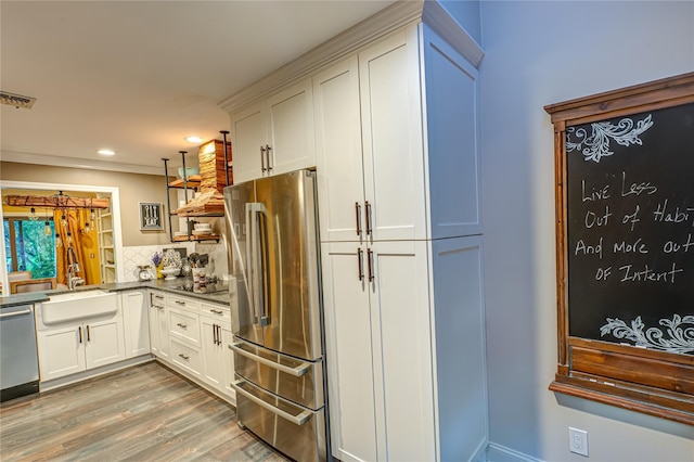 60 Jeremy Cir, Nesconset, NY 11767 - kitchen with appliances with stainless steel finishes, recessed lighting, light wood-style flooring, decorative backsplash, and white cabinets