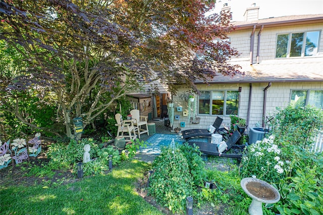 60 Jeremy Cir, Nesconset, NY 11767 - rear view of property with a chimney, a shingled roof, a patio, and outdoor lounge area