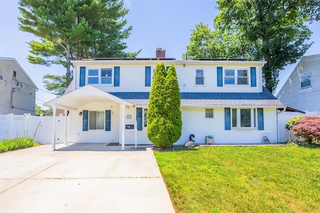 4 Wagon Ln, Levittown, NY 11756 - traditional-style house featuring concrete driveway and a chimney