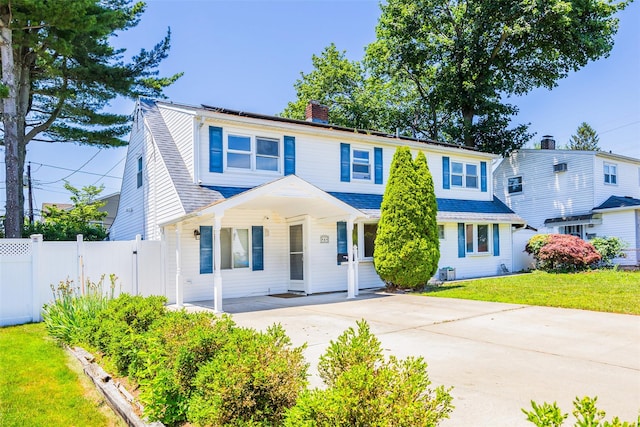 4 Wagon Ln, Levittown, NY 11756 - view of front of home featuring covered porch, a chimney, and driveway
