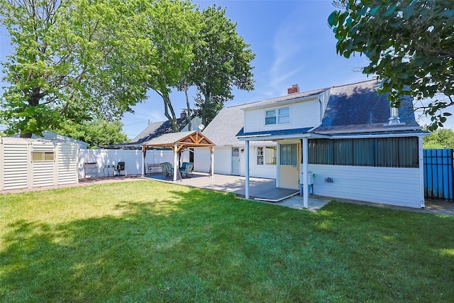 4 Wagon Ln, Levittown, NY 11756 - rear view of house with a gazebo, a fenced backyard, a shed, a patio area, and a chimney