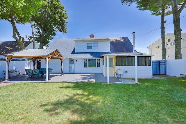 4 Wagon Ln, Levittown, NY 11756 - rear view of house with a fenced backyard, a shingled roof, a chimney, a sunroom, and a deck