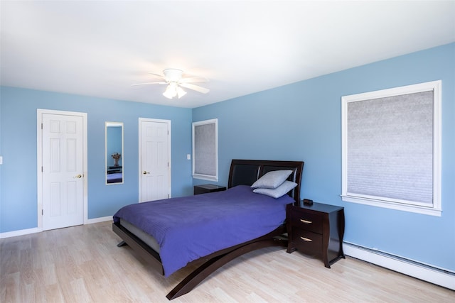 4 Wagon Ln, Levittown, NY 11756 - bedroom with a baseboard radiator, wood finished floors, and ceiling fan