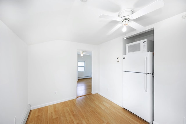 4 Wagon Ln, Levittown, NY 11756 - kitchen with white appliances, ceiling fan, light wood finished floors, a baseboard heating unit, and a baseboard radiator