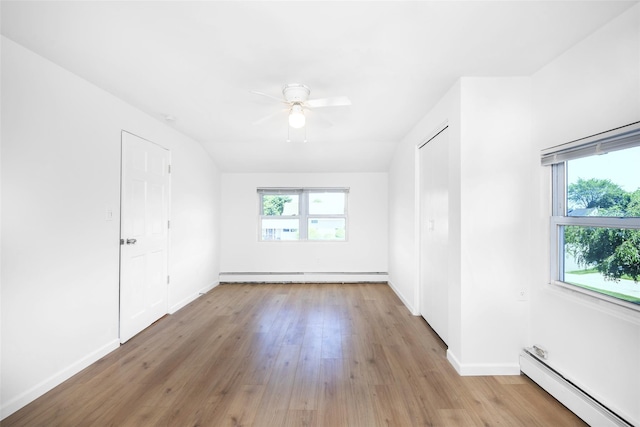 4 Wagon Ln, Levittown, NY 11756 - unfurnished room featuring a baseboard radiator, a ceiling fan, and wood finished floors