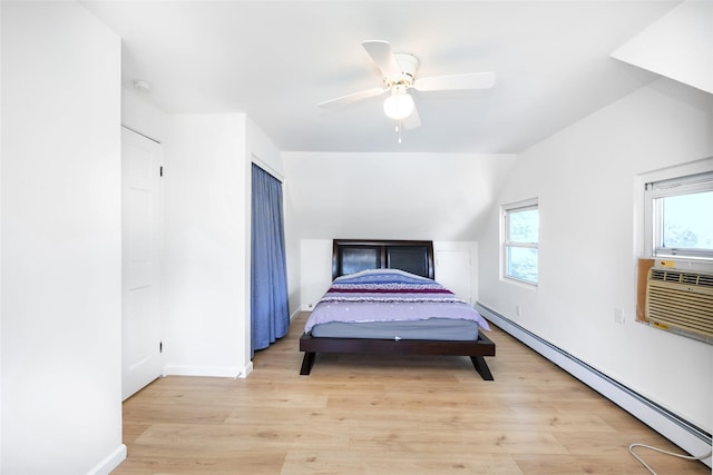 4 Wagon Ln, Levittown, NY 11756 - bedroom with a baseboard radiator, light wood-type flooring, vaulted ceiling, and ceiling fan