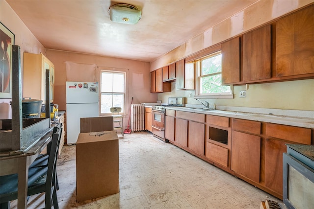 50 Maple St, Catskill, NY 12414 - kitchen featuring freestanding refrigerator, gas stove, light countertops, and brown cabinets