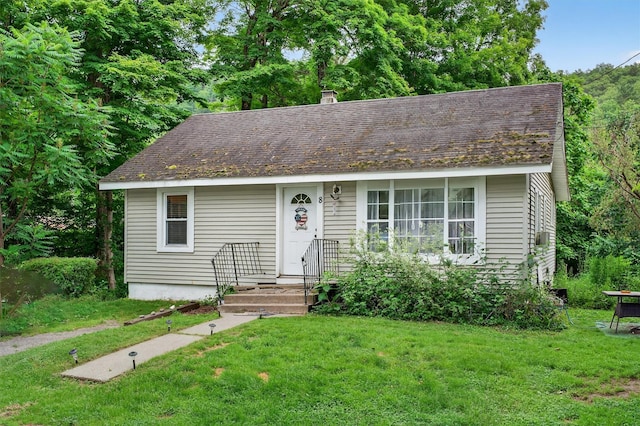 8 First St, Godeffroy, NY 12729 - view of front of home featuring a front yard and a shingled roof