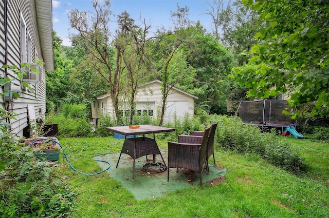 8 First St, Godeffroy, NY 12729 - view of green lawn featuring a trampoline, an outdoor structure, and outdoor dining space