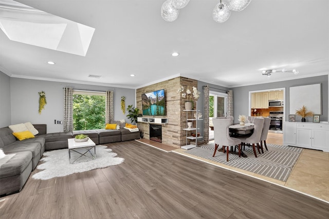 46 Alta Pl, Yonkers, NY 10710 - living area featuring crown molding, healthy amount of natural light, light wood finished floors, a skylight, and recessed lighting