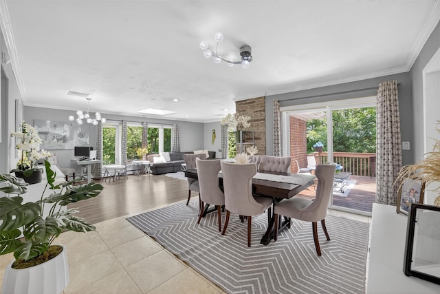 46 Alta Pl, Yonkers, NY 10710 - tiled dining room featuring plenty of natural light, a chandelier, and crown molding
