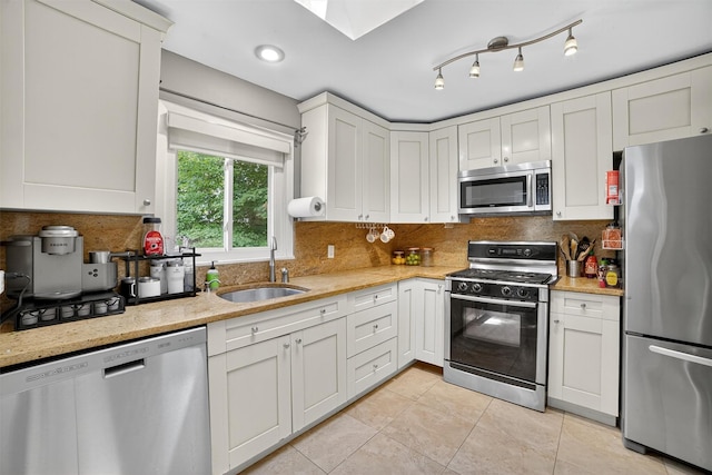 46 Alta Pl, Yonkers, NY 10710 - kitchen featuring stainless steel appliances, light tile patterned floors, tasteful backsplash, white cabinetry, and light stone countertops