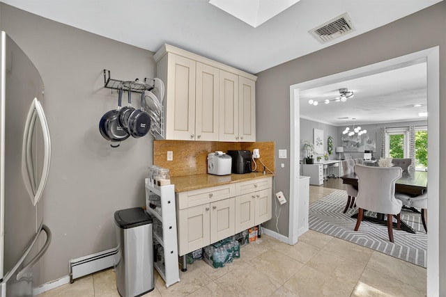 46 Alta Pl, Yonkers, NY 10710 - kitchen with freestanding refrigerator, a baseboard radiator, decorative backsplash, a skylight, and light tile patterned floors