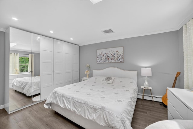 46 Alta Pl, Yonkers, NY 10710 - bedroom featuring a baseboard heating unit, crown molding, wood finished floors, recessed lighting, and a closet