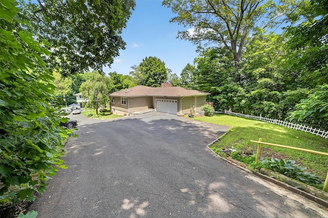 46 Alta Pl, Yonkers, NY 10710 - view of front facade with an attached garage, asphalt driveway, a chimney, and view of scattered trees