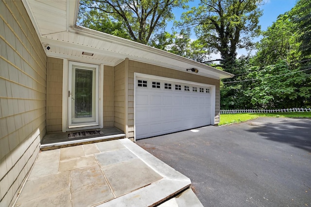 46 Alta Pl, Yonkers, NY 10710 - entrance to property featuring asphalt driveway, a security system, and an attached garage