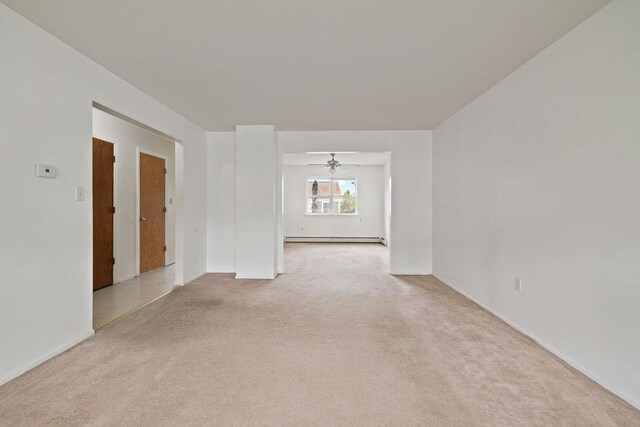 180 Depew Ave, Nyack, NY 10960 - spare room featuring light carpet, a baseboard heating unit, and a ceiling fan