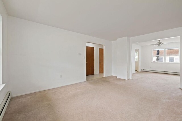 180 Depew Ave, Nyack, NY 10960 - unfurnished living room featuring a baseboard radiator, baseboard heating, light carpet, and a ceiling fan