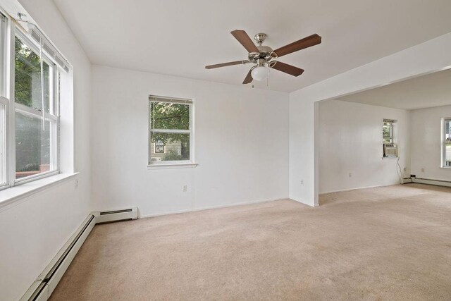180 Depew Ave, Nyack, NY 10960 - empty room with a baseboard heating unit, light carpet, and ceiling fan