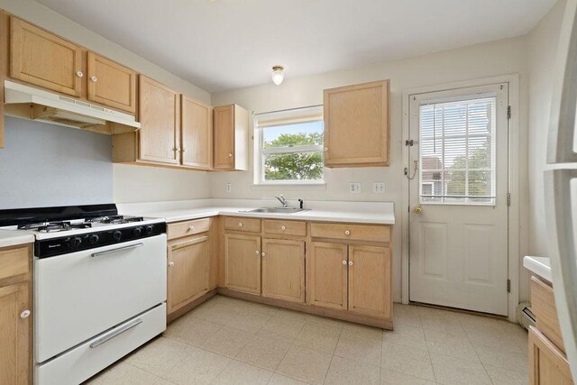180 Depew Ave, Nyack, NY 10960 - kitchen with white range with gas stovetop, under cabinet range hood, light brown cabinets, and light countertops