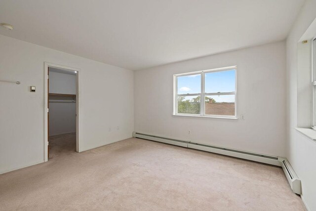 180 Depew Ave, Nyack, NY 10960 - unfurnished bedroom with light colored carpet, a baseboard radiator, and a walk in closet