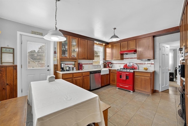 167 Hillview Ave, Yonkers, NY 10704 - kitchen featuring range with gas stovetop, dishwasher, under cabinet range hood, and brown cabinets