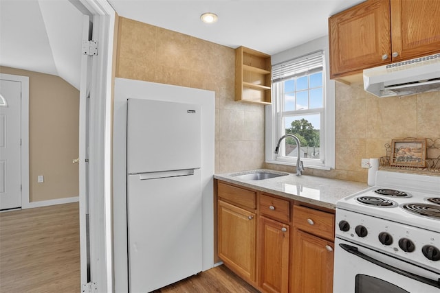 167 Hillview Ave, Yonkers, NY 10704 - kitchen featuring white appliances, under cabinet range hood, light wood-style floors, light stone countertops, and decorative backsplash