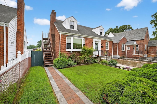 167 Hillview Ave, Yonkers, NY 10704 - new england style home featuring brick siding, a fenced backyard, stairway, a chimney, and a shingled roof