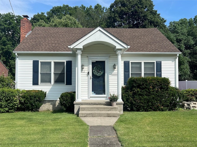 212 N St, Newburgh, NY 12550 - bungalow featuring a front yard, roof with shingles, and a chimney