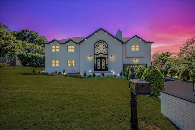 3 Fairview Ln, Glen Cove, NY 11542 - view of front of home featuring a chimney, an attached garage, a yard, and stucco siding