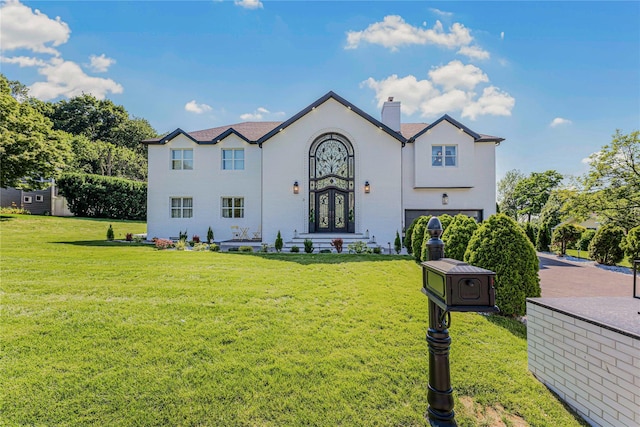 3 Fairview Ln, Glen Cove, NY 11542 - view of front of home with a chimney, a garage, a front lawn, and french doors