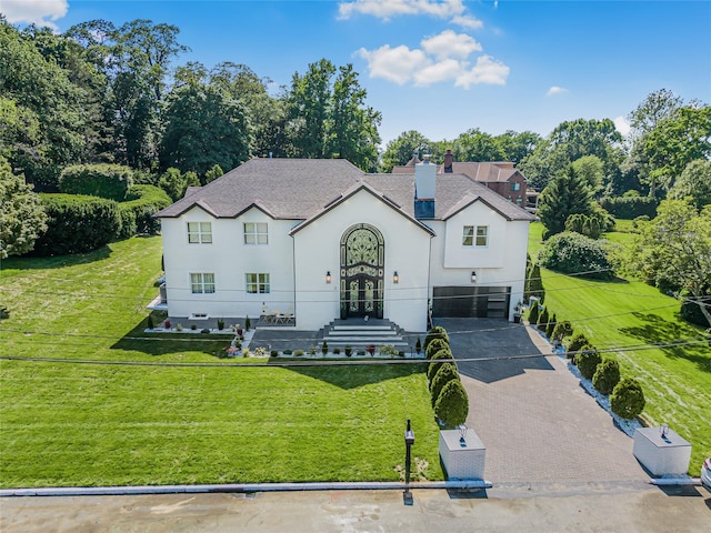 3 Fairview Ln, Glen Cove, NY 11542 - traditional-style house featuring asphalt driveway, a garage, a front lawn, and stucco siding